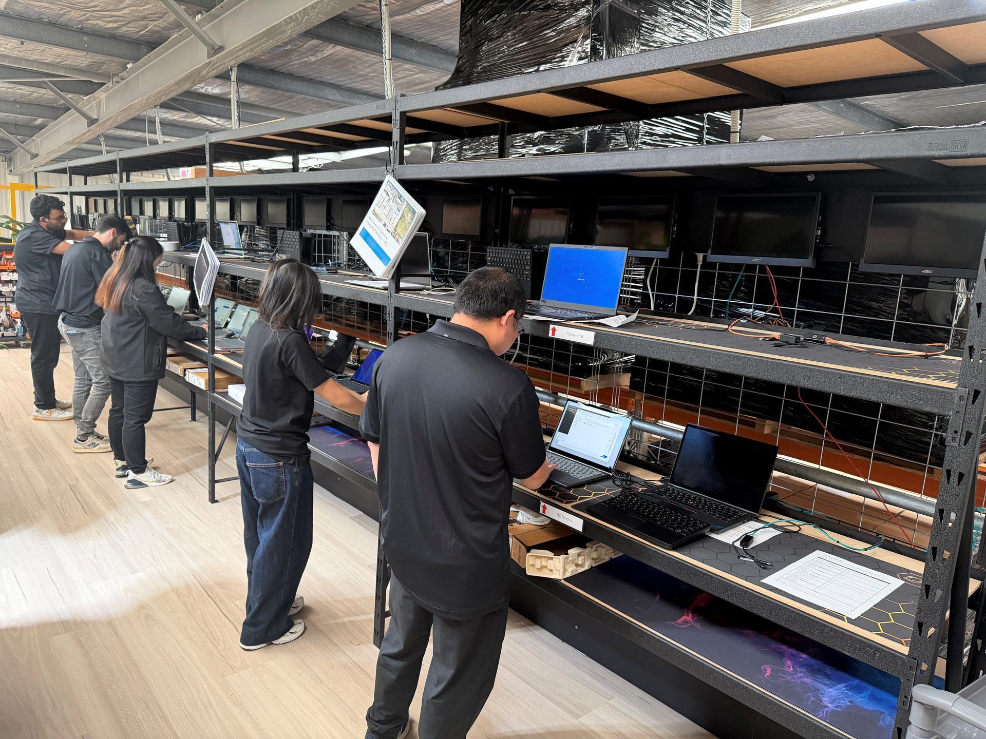 System Squared engineers configuring and imaging laptops at the Sydney North integration centre
